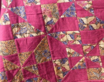Red patchwork quilt with Thai patterns