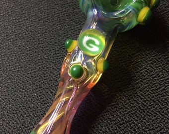Green Bay Glass pipe. Green Bay millie with green wrap and highlights. Fumed with silver and gold, color changing. Awesome piece
