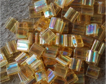 MIYUKI TILA Beads, 2 Hole, 5mm Square, Transparent Light Topaz AB , sold in units of approx 10gms.