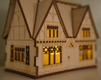 Intricate laser cut thatched cottage nightlight