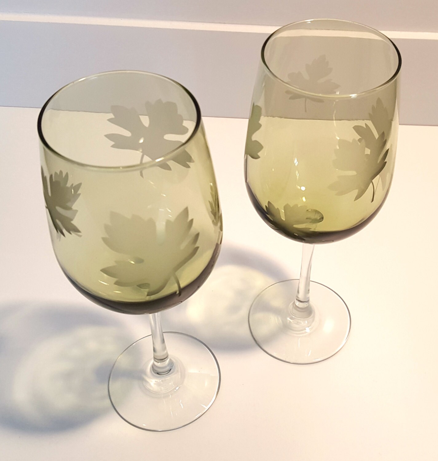 Etched wine glasses with maple leaf. Green glassware