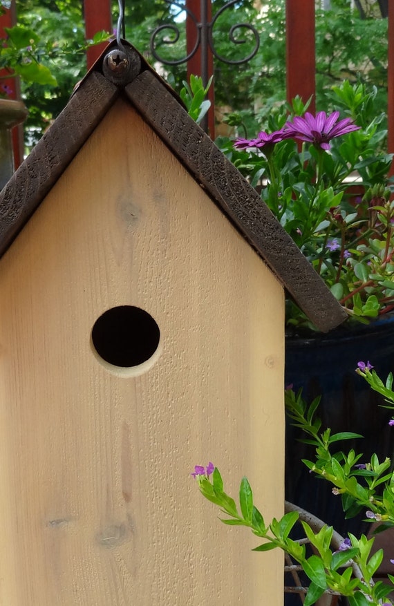 Yellow handcrafted birdhouse for sale with rusty tin roof