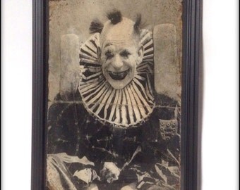 Aged reproduction Victorian creepy clown in frame.