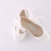 white flats with ribbon