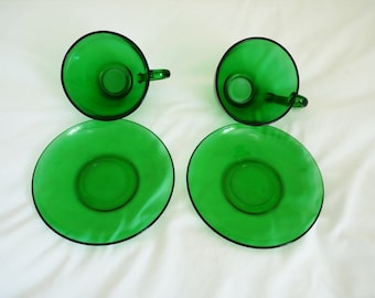 Two vintage green Arcoroc France glass coffee cups with saucers 1960s