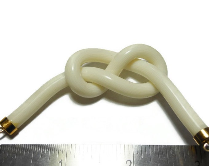 Cream knot focal charm, acrylic and gold-finished, opaque striated , 3" x1" knot, 2 loops, almost instant necklace or get creative