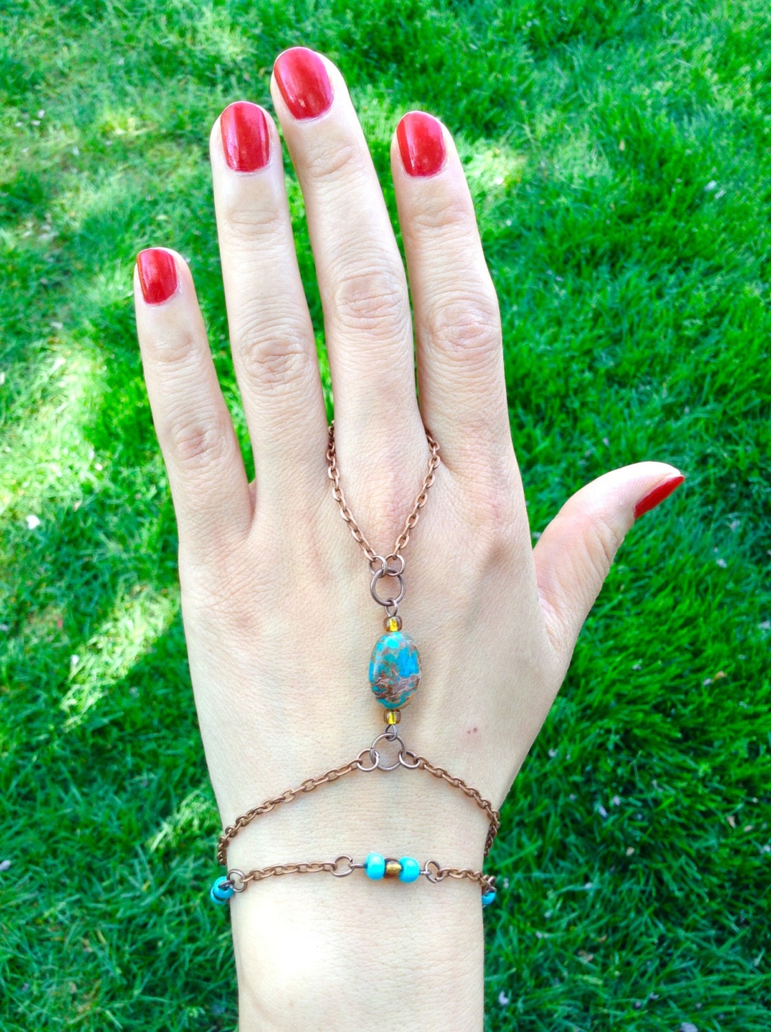 Antique copper slave bracelet with central blue imperial