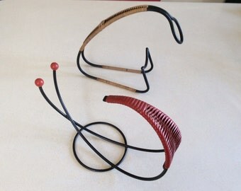 Pair of 1950s wirework 'atomic' red wine bottle servers.