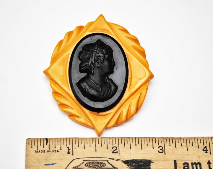 Large Bakelite Cameo brooch with black and butterscotch carved vintage plastic pin