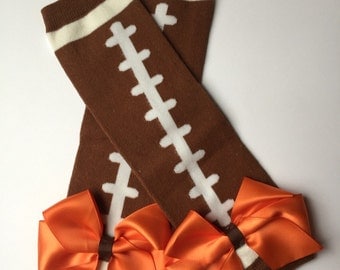 Cleveland football baby leg warmers, football leg warmers, Brown & white football leg warmers with orange satin bows, browns baby football