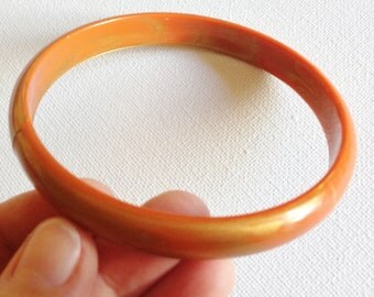 Bangle - orange plastic bangle with gold lustre colour inclusion