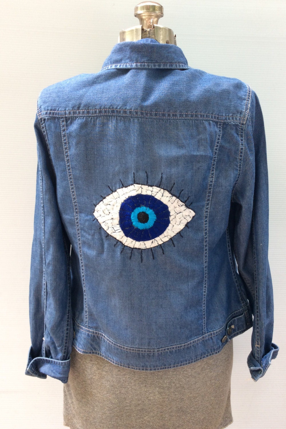Hand embroidered evil eye denim jacket by savingmyvintageheart