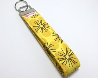 Keychain. Key fob. Wristlet keychain. Key wristlet. Key holder. Black sunburst on yellow polka dot fabric.