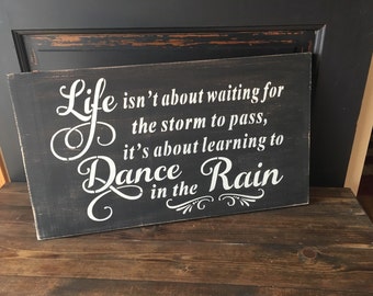 Life isn't about waiting for the storm to pass but learning to dance in the rain, wooden inspirational sign
