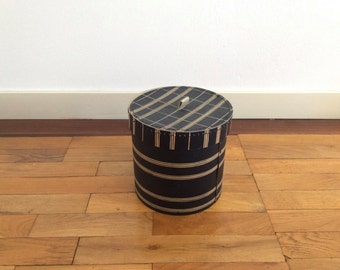 Small vintage cardboard hat box or storage box in dark blue with off-white decorative horizontal bands