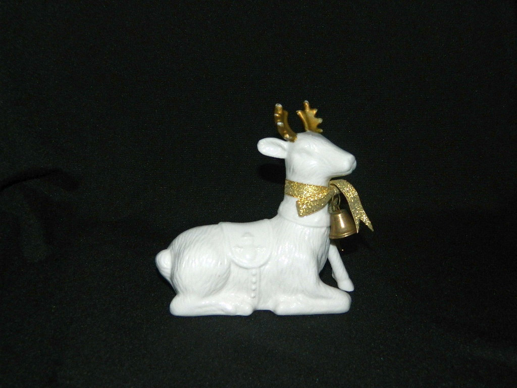 white and gold ceramic reindeer