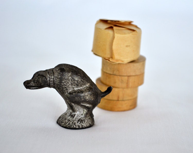 pooping dog figurine