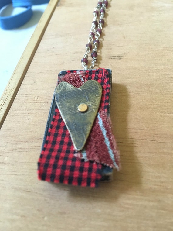 Etched copper heart riveted to domino #1 with silk