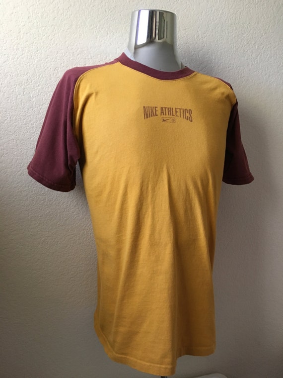 mustard yellow nike shirt