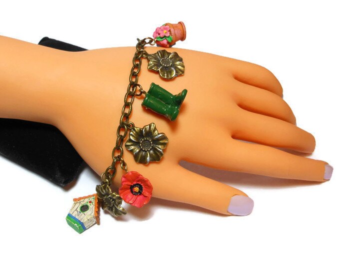 Gardening charm bracelet, upcycled colorful garden charms mixed with bronzed flowers with silver highlights on a bronze link bracelet