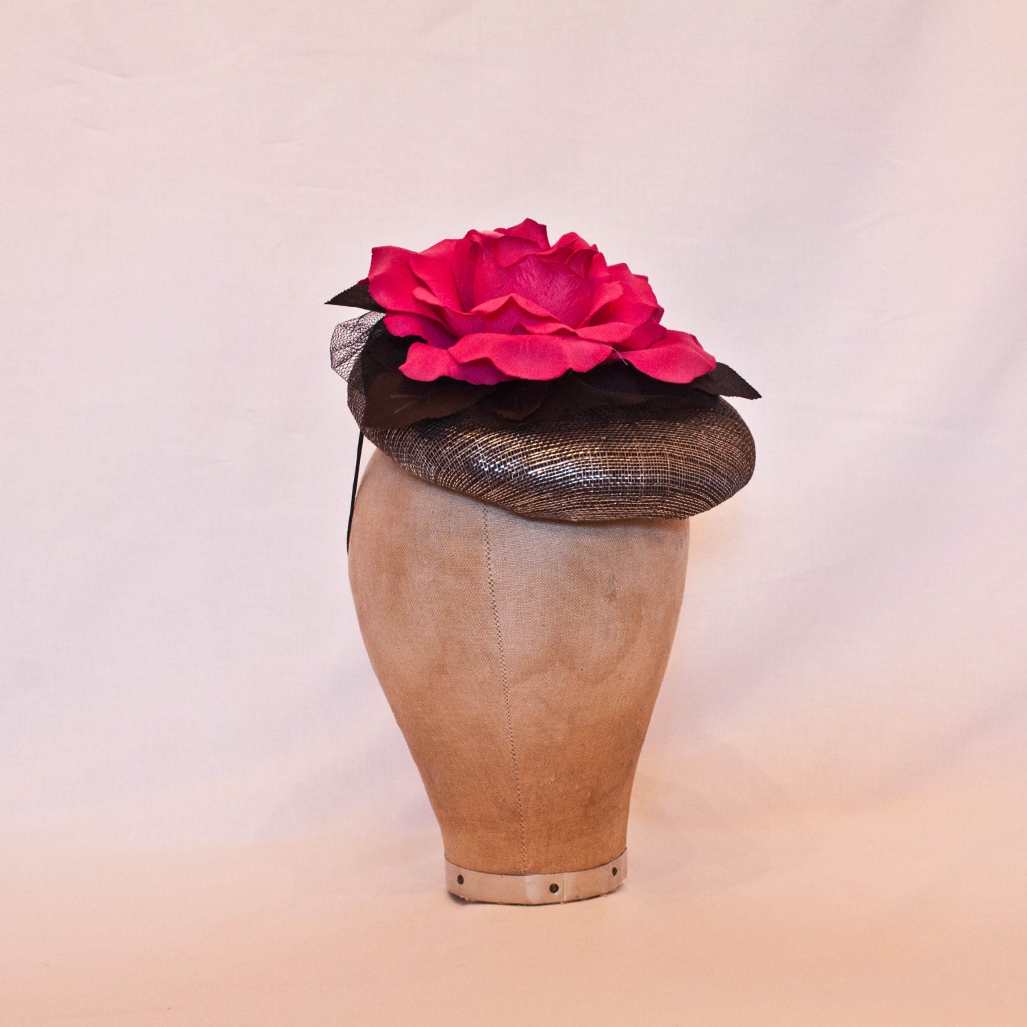 Stunning gunmetal coloured occasion hat with fuchsia pink rose decoration