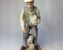 man and dog figurine