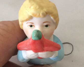 Darling little porcelain tiny baby doll with it's own toy airplane