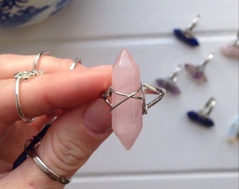 Pastel pink rose quartz wire wrapped crystal ring on silver tone base.
