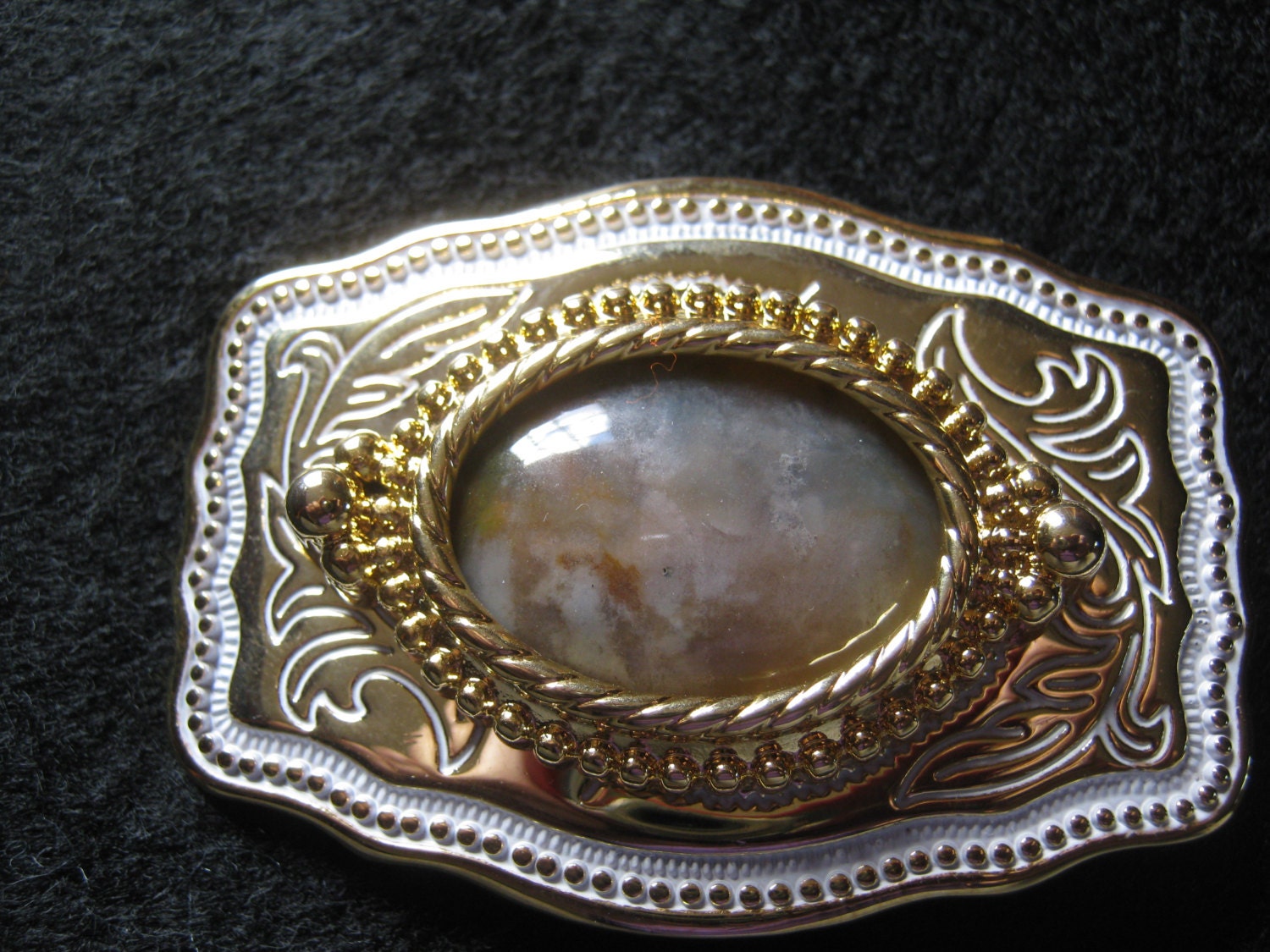 Belt Buckle. Western Style. Gold tone with white trim. Fancy