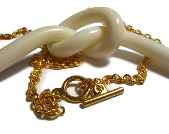 Cream knot necklace, creamy white striated knot focal plays center stage with a gold plated link chain and toggle clasp