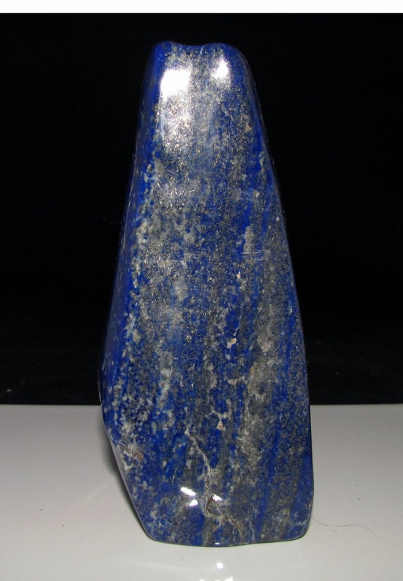 natural smooth polished dark blue lapis lazuli rock stone