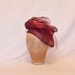 Handmade plum coloured ladies hat decorated with tulle, veiling and handmade rose