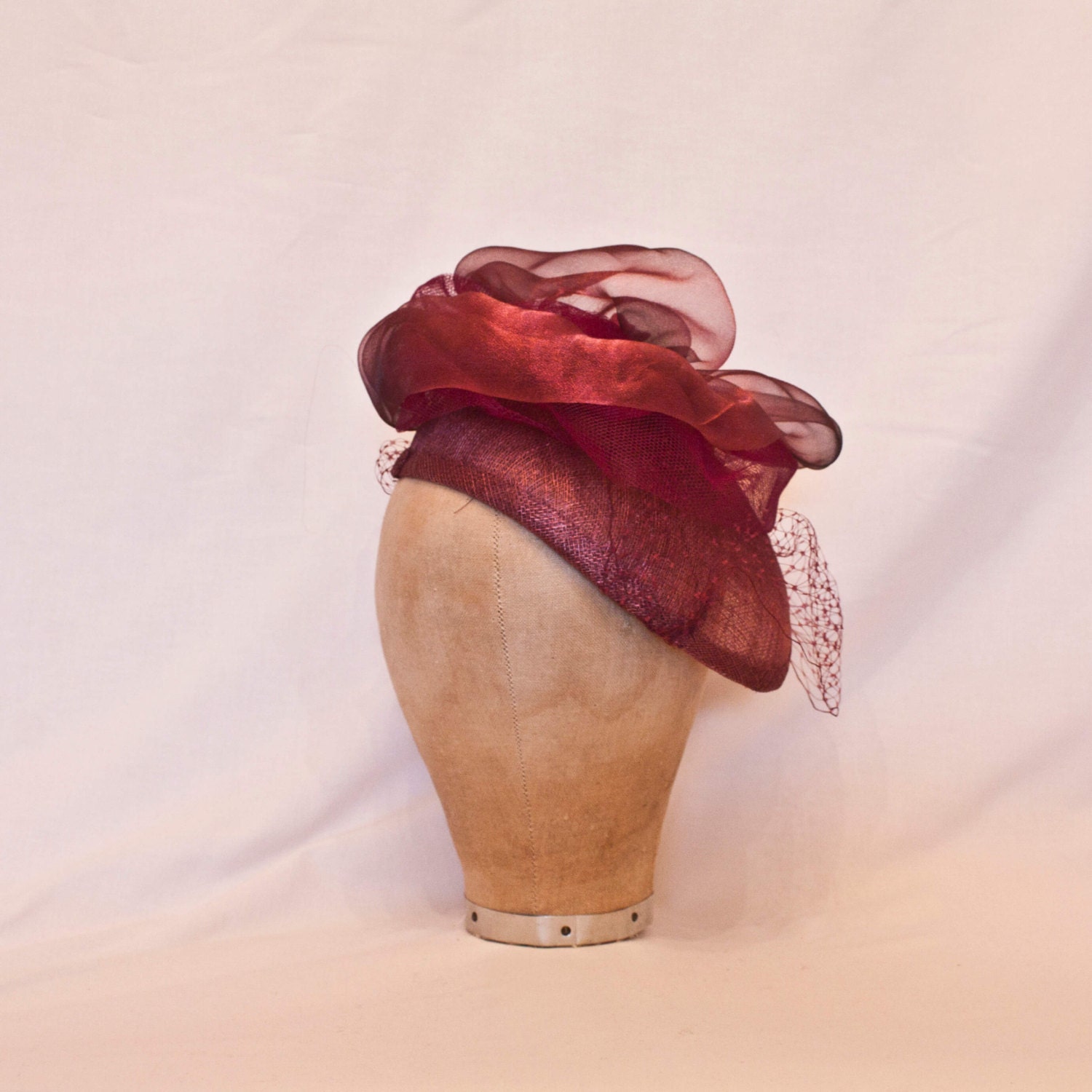 Handmade plum coloured ladies hat decorated with tulle, veiling and handmade rose