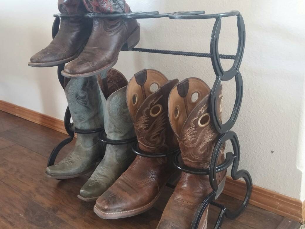 Horseshoe boot rack holds four pairs of boots.