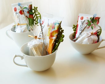 Relaxing Tea Cup Gift Set: 3 teabags, 3 flavored sugars, 1 felt coaster, 1 jeweled stir spoon all in a lovely tea cup