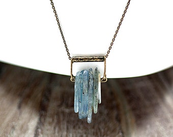 Art deco style aquamarine swing necklace. Light blue / turquoise / green on antique gold / black patinated bar. Small statement necklace.