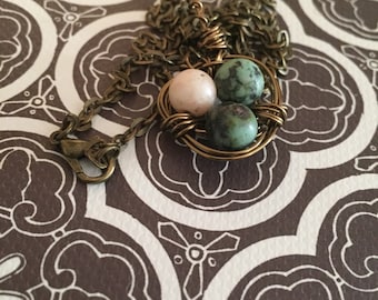 Beautiful, 3 eggs in birds nest pendant with chain