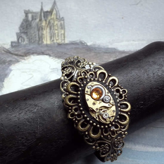 Ajustable filigree vintage steampunk bracelet with framed mechanism, black resin, watch mecanism, yellow Swarovski flat Cab by FranZainalSteampunk steampunk buy now online