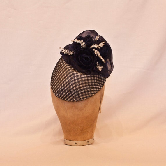 Unique handmade navy and white tear drop shaped ladies hat, decorated with handmade ribbon roses and beading