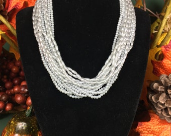 Multilevel silver tone beaded 15'' choker, with a gold tone facet with a replica Roman coin inside the facet