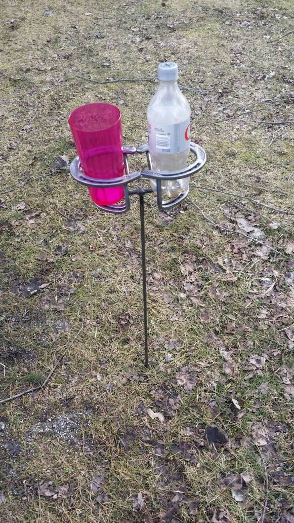 Double horseshoe drink holder. Outdoors. campfire. Beer.