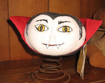 Drac-o-lantern - stuffed fabric Dracula on a rusty spring