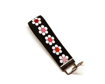 Beautiful daisies fabric wrist key fob key chain wristlet. Black and pink.
