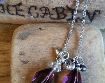 Lariat style necklace with purple crystal and silver charms