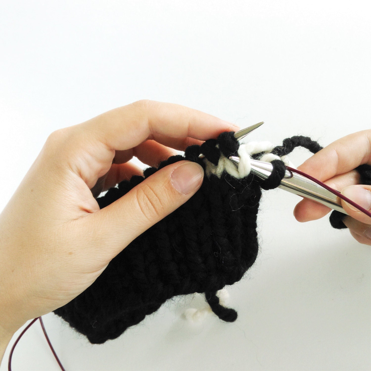 Pick up the stitch below the next stitch and place it on the left needle.