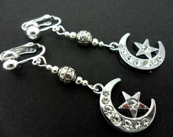 A pair of pretty diamante silver plated moon and star dangly clip on earrings.