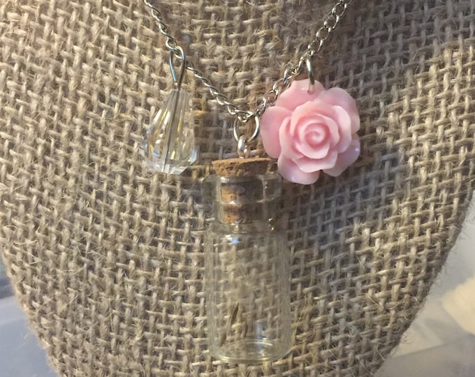 Wish in a bottle with a pink flower