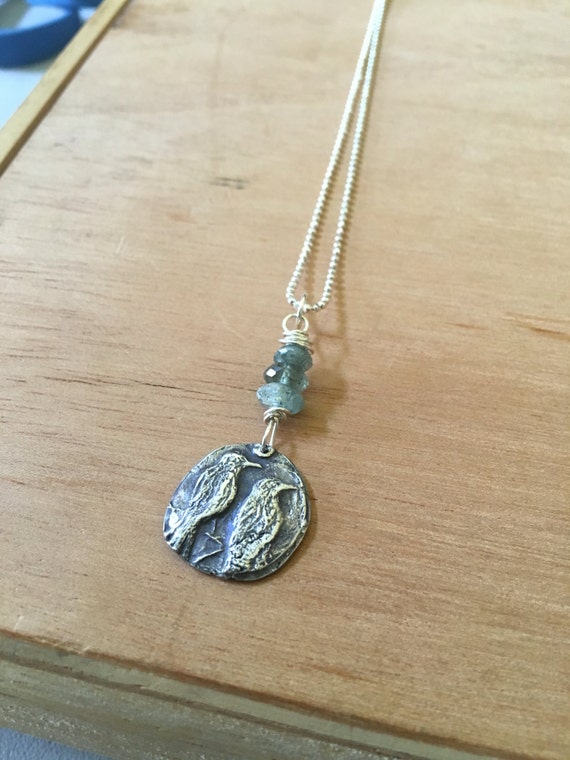 Two crows: fine silver one of a kind pendant with green labradorite. "Crow power" on back, sterling silver necklace