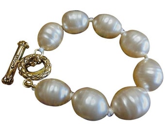 Vintage CHANEL extra large faux baroque pearl bracelet with logo embossed hardware. Rare vintage jewelry from Chanel.