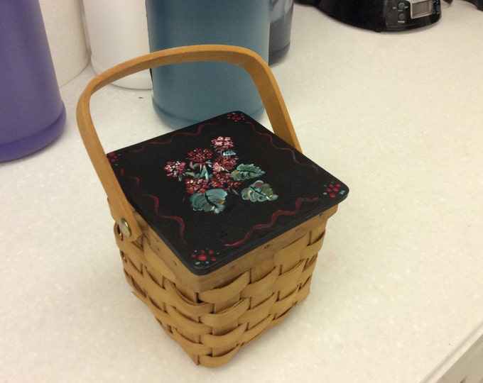 Wicker Basket has Wood hinged lid with Geraniums painted on top